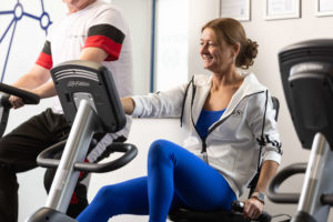 A lady on an exercise bike